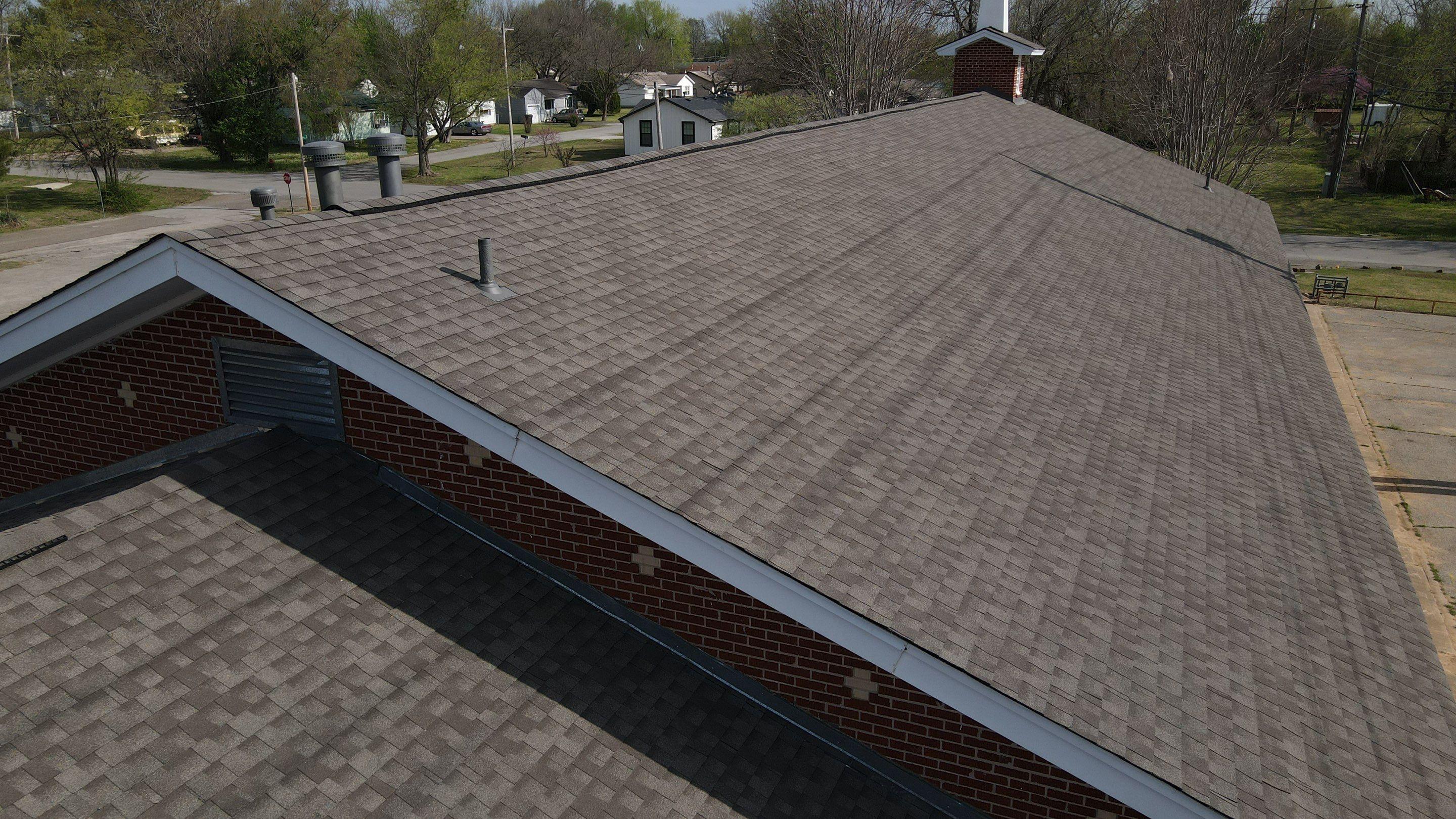 Aerial drone shot of a finished church roof replacement