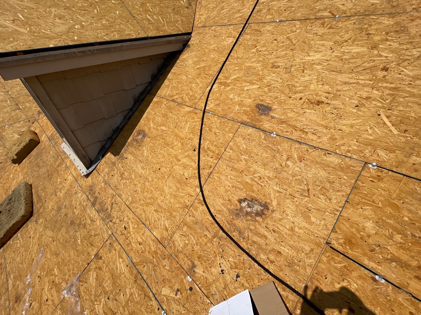 Rotten OSB decking and hidden roof leaks exposed during tear-off