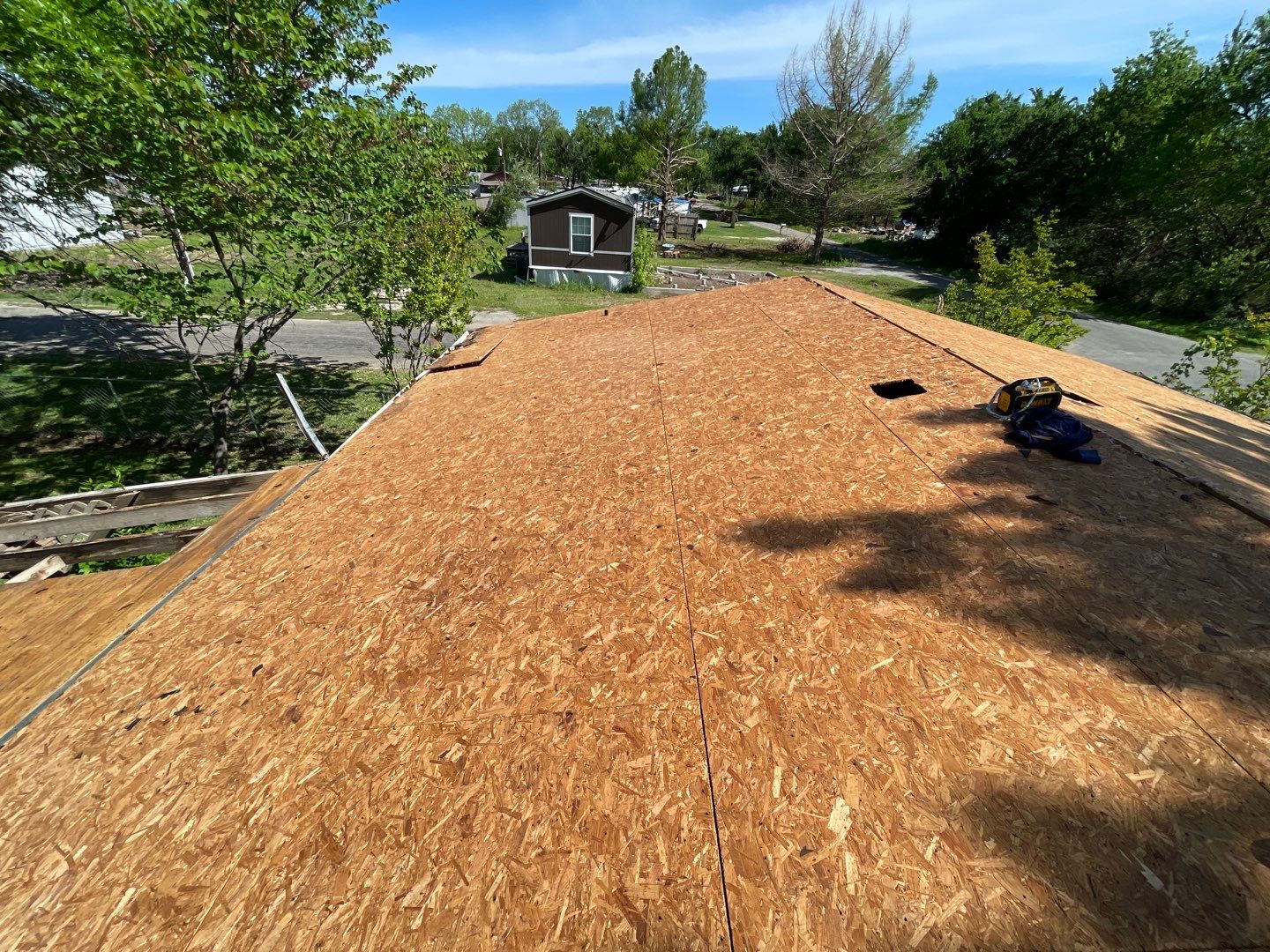 Lake home new OSB decking installation during full tear-off after storm damage